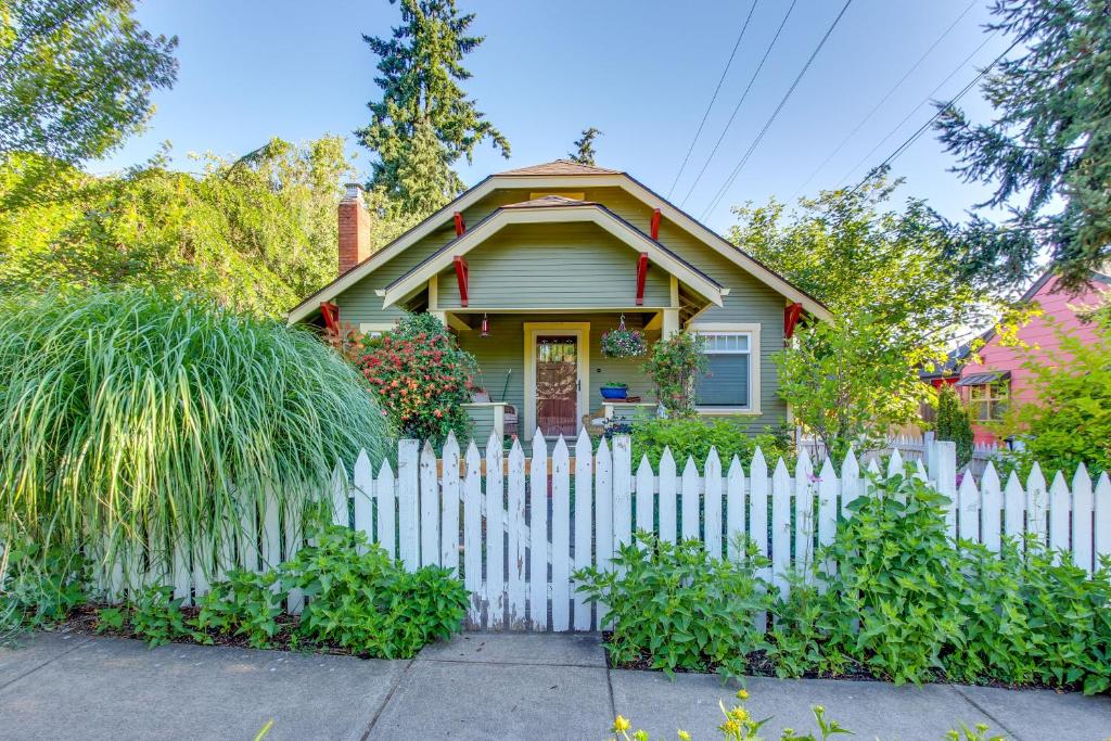 a white picket fence in front of a house at Charming Eugene Vacation Home 1 Mi to Dtwn! in Eugene