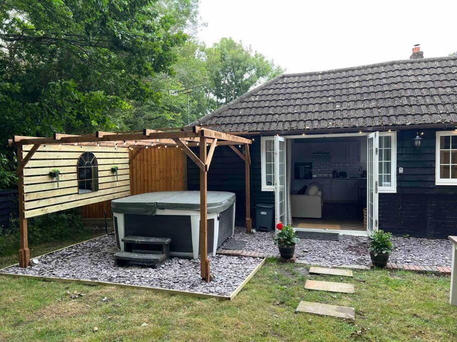 a backyard with a hot tub and a house at Hot Tub hideaway! New Forest in Cadnam