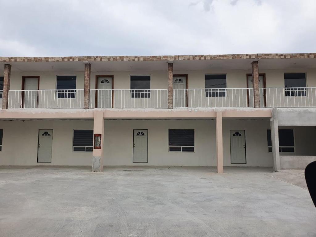 a large building with doors and a balcony at HOSPEDAJE DOÑA ENEDINA in Ciudad Acuña