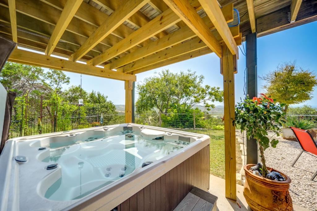 a jacuzzi tub on the patio of a house at Fredericksburg Retreat with Private Hot Tub and Patio! in Fredericksburg