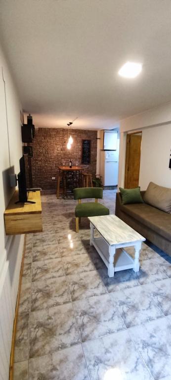 a living room with a couch and a table at Solaire Apart in Ciudad Lujan de Cuyo