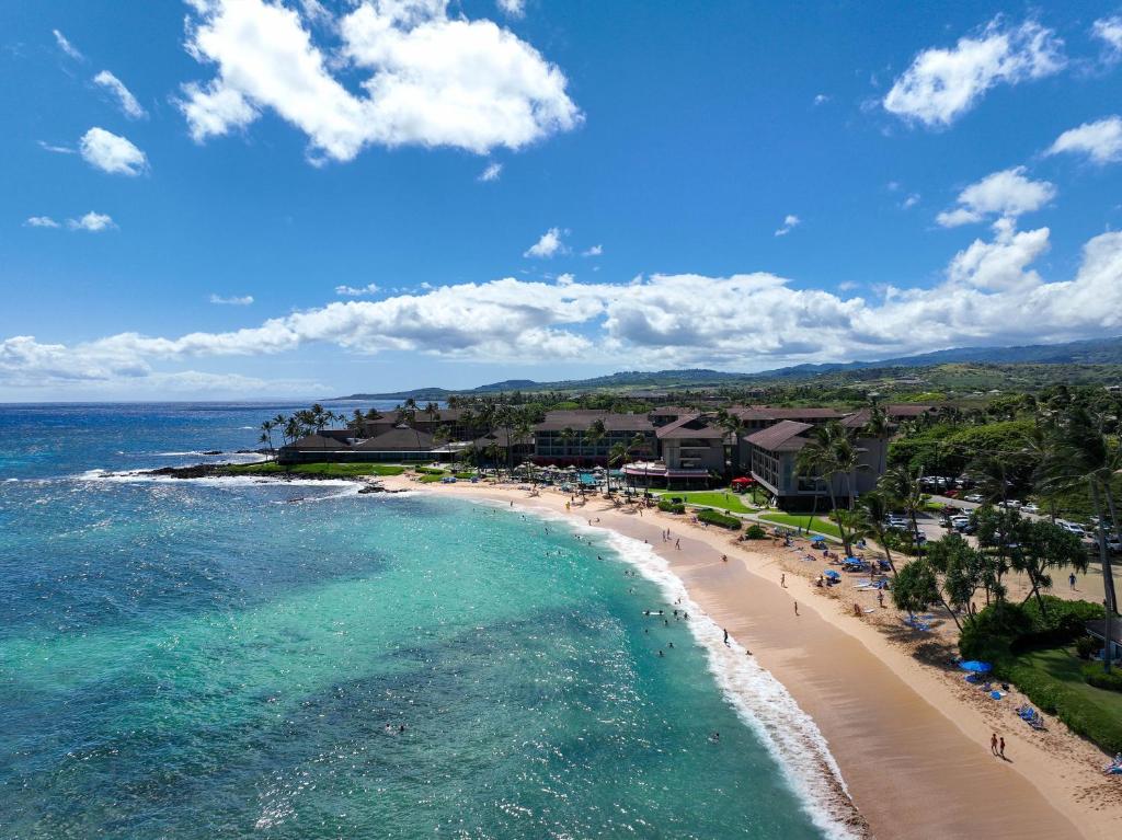 an aerial view of a beach with people and the ocean at Kiahuna Plantation in Koloa