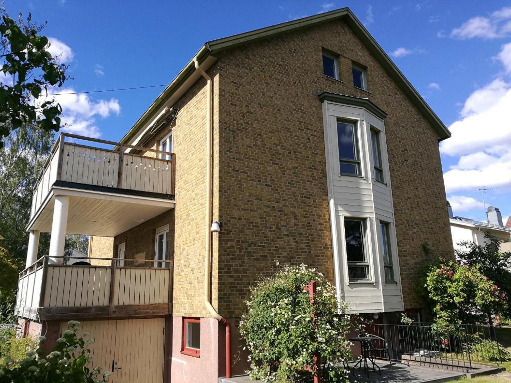 a large brick house with a balcony on top at Eldaren in Tranås