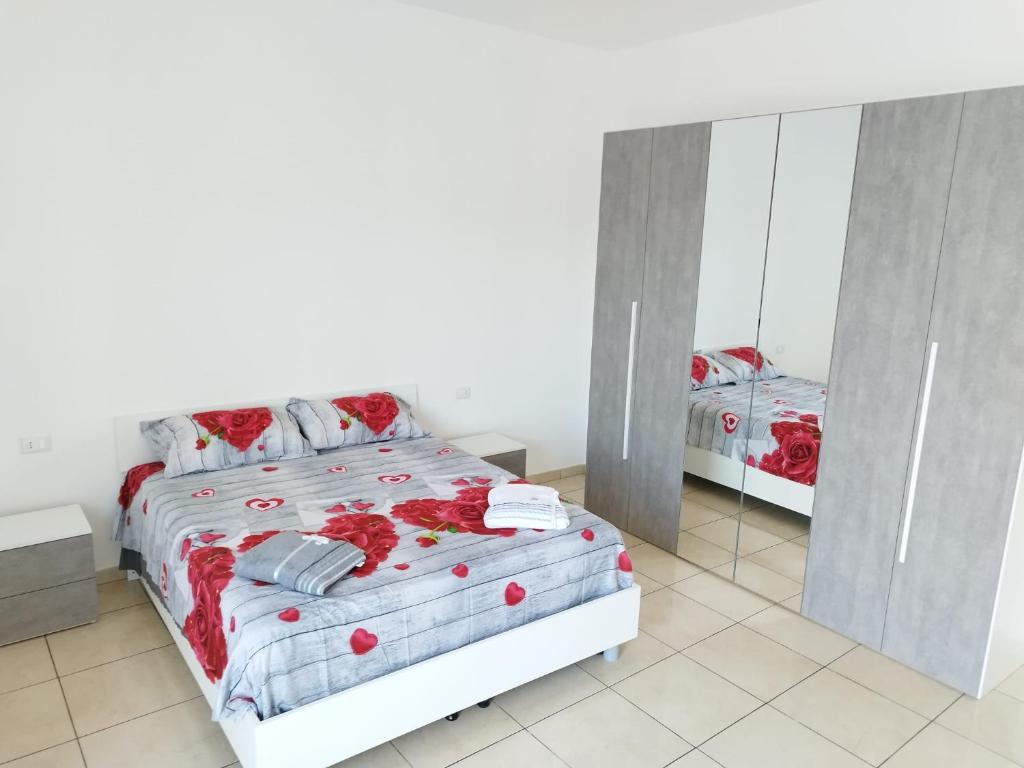 a bedroom with a bed and a mirror at Luan's House in Pozzallo