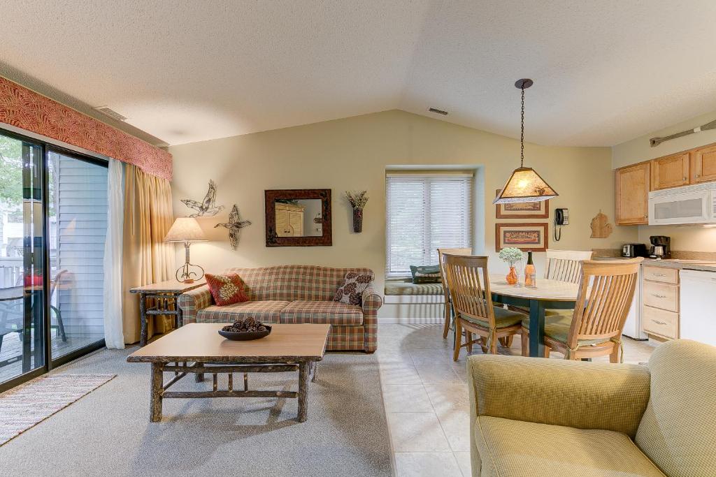 a living room with a couch and a table at Cozy Country Lakeside Condo 5705 in Traverse City