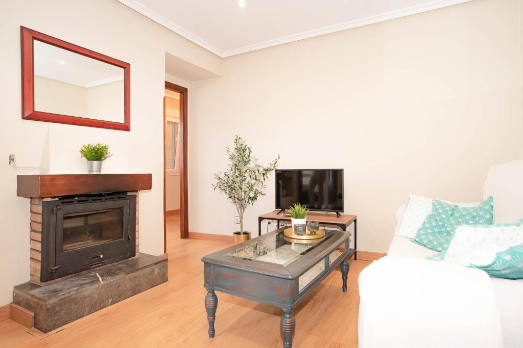 a living room with a couch and a fireplace at 10A02 Precioso apartamento Pravia in Pravia