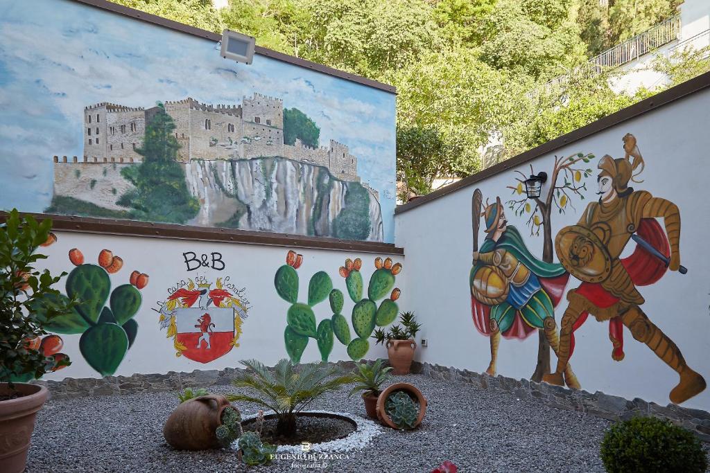 a mural on the side of a building with cactus at La Casa Dei Cavalieri in Caccamo