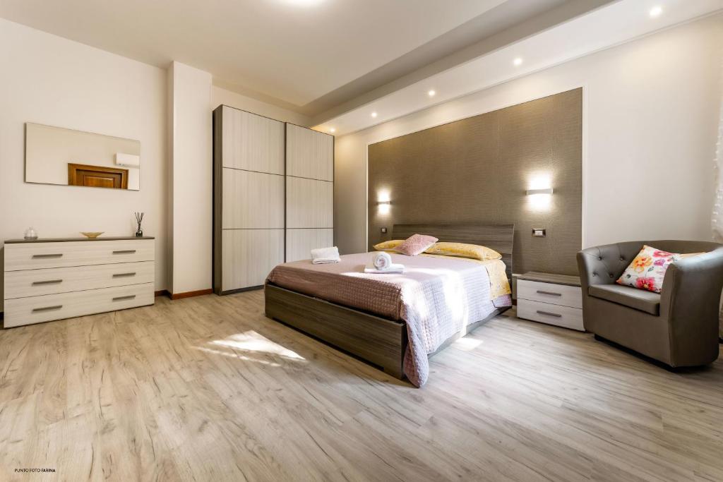 a bedroom with a bed and a chair at Casa Assunta in Tresnuraghes