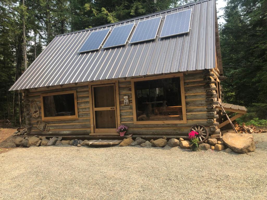 a cabin with solar panels on top of it at Mini Moo-light Cabin in Clearwater