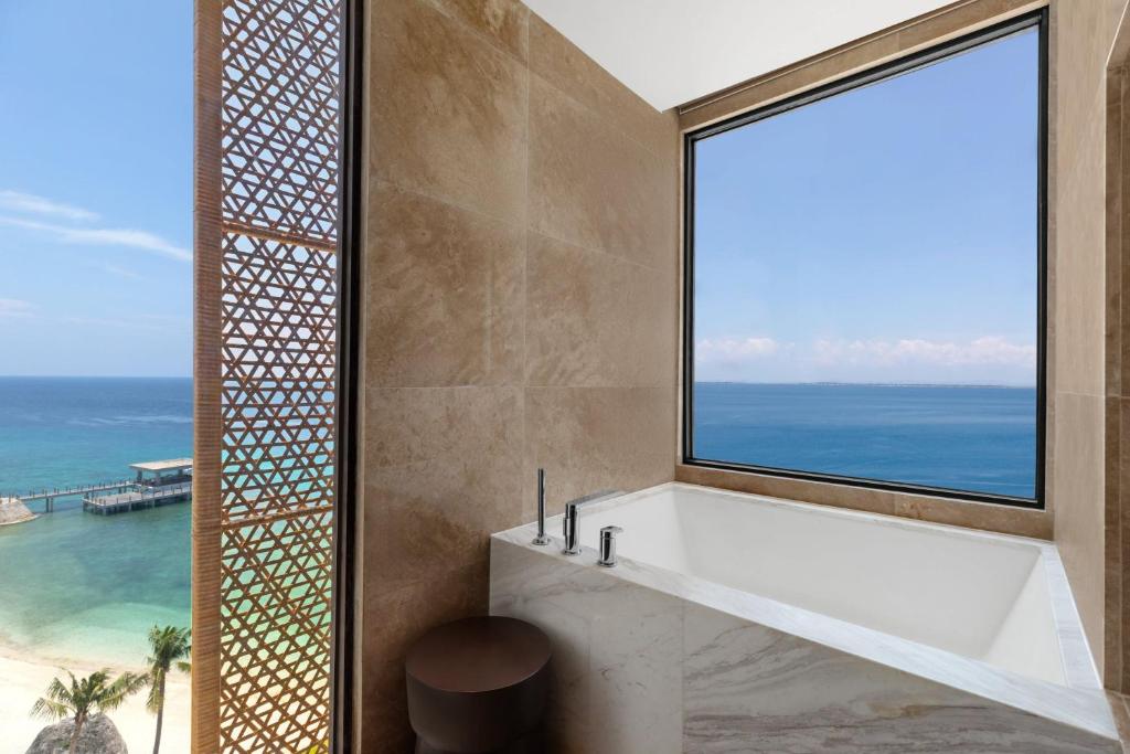 a bathroom with a view of the ocean at Sheraton Cebu Mactan Resort in Mactan