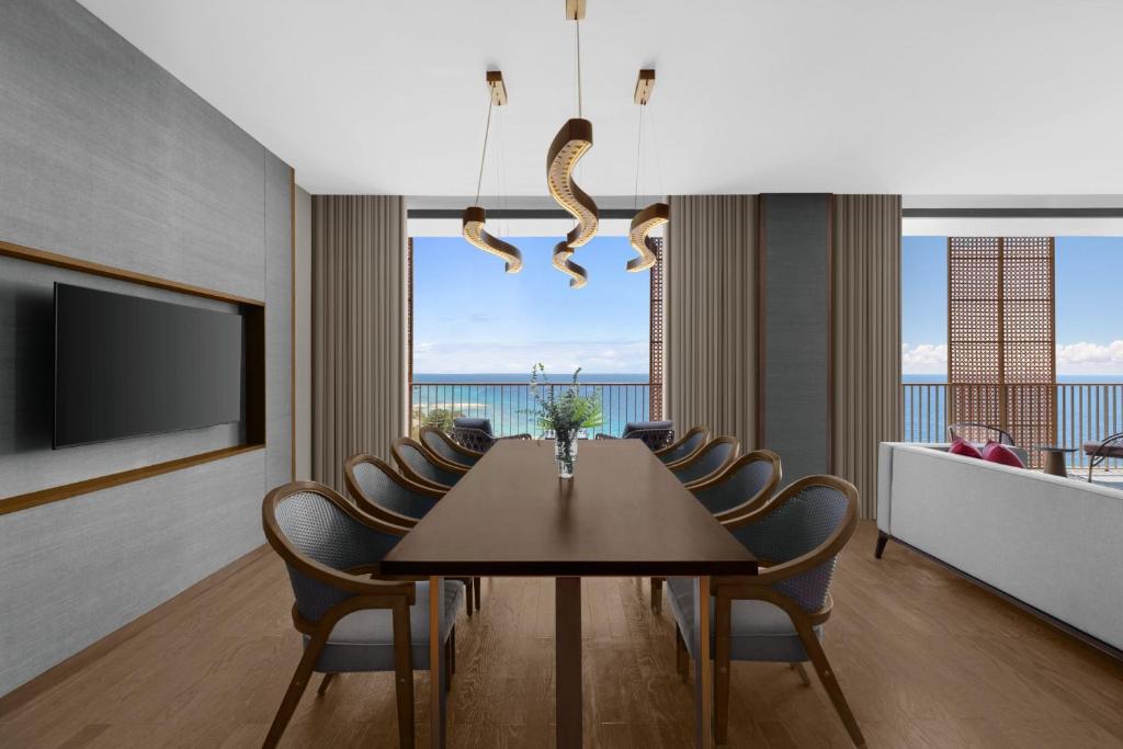 a dining room with a table and chairs and a television at Sheraton Cebu Mactan Resort in Mactan