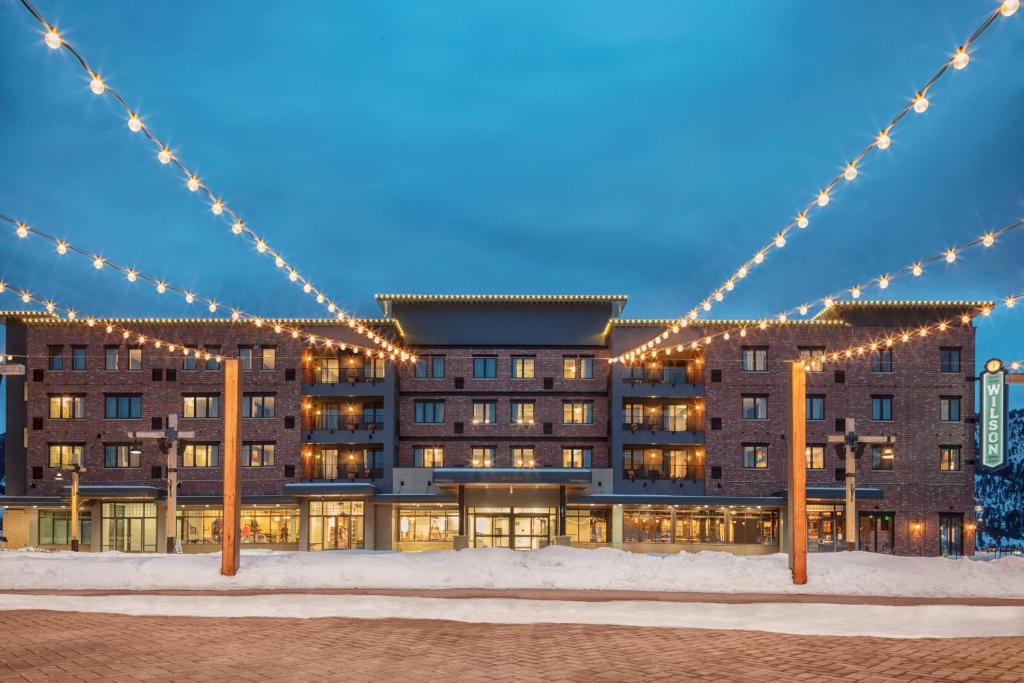 a large building with christmas lights on it at Residence Inn by Marriott Big Sky/The Wilson Hotel in Big Sky