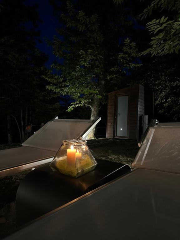 a candle sitting on top of a table at night at Il Bosco di Paolo - Glamping in Sestola