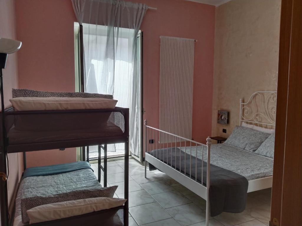 a bedroom with two bunk beds and a bed at Casa Vacanze Arturo in Bari