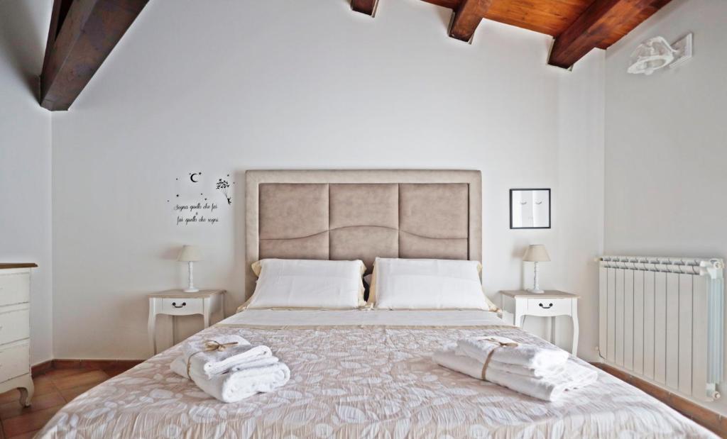 a bedroom with a large bed with towels on it at La Casa di Filippo in Palermo