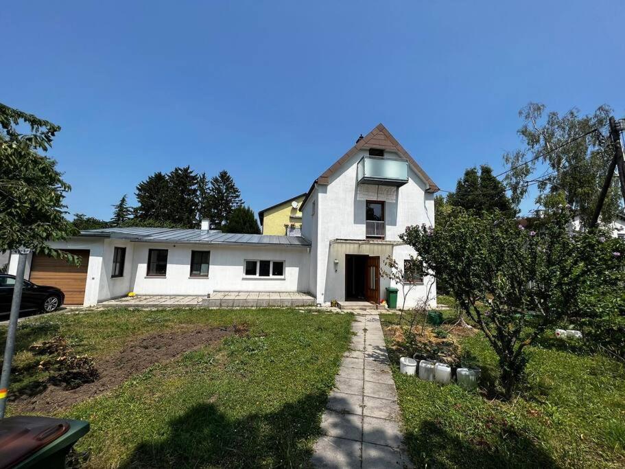 a white house with a driveway in front of it at Central-Vintage Villa with free Parking and 5min walk to Metro in Vienna