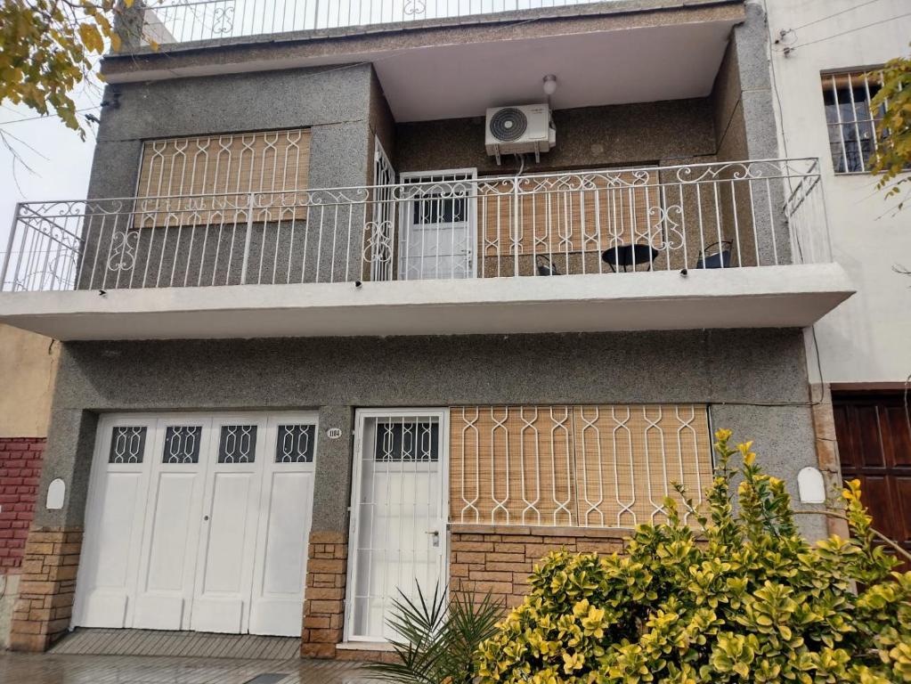 a apartment building with a balcony and a porch at CASA OLGUITA in Godoy Cruz
