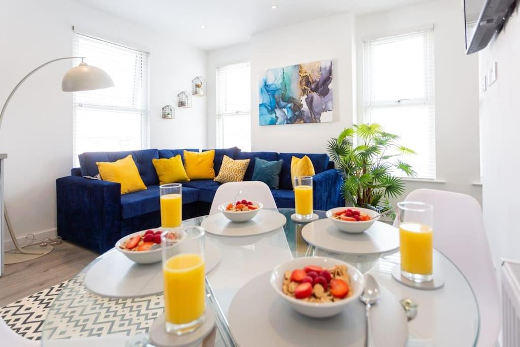 a living room with a table with bowls of food at 2 bed apartment near the beach in Southend-on-Sea