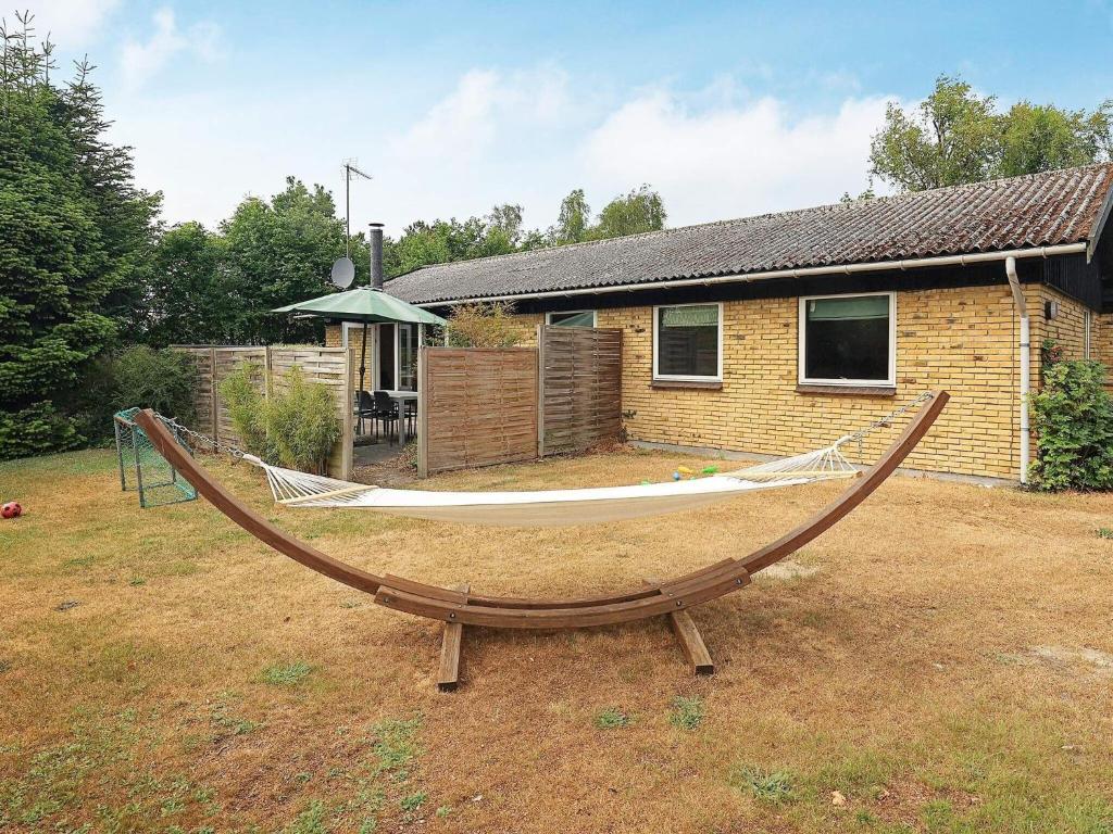 a hammock in a yard in front of a house at 6 person holiday home in V ggerl se in Marielyst