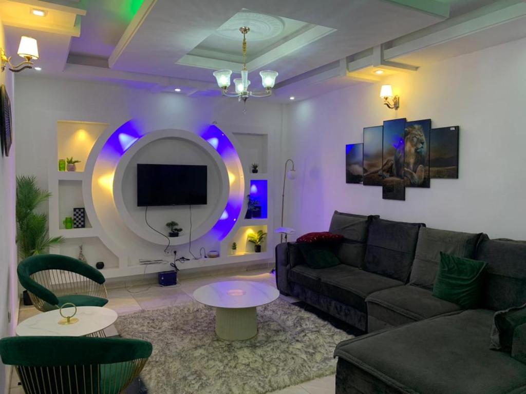 a living room with a couch and a tv at Deluxe Mansion in Buea