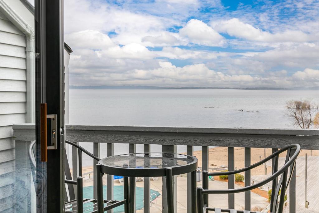 a balcony with a table and a view of the beach at Beautiful Bay View Couples Retreat at The Shores 5586 in Traverse City