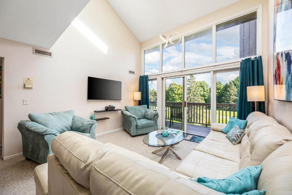 a living room with a couch and chairs and a tv at Beautiful 2BDR Loft Suite at Golf Course Condo 5549 in Traverse City