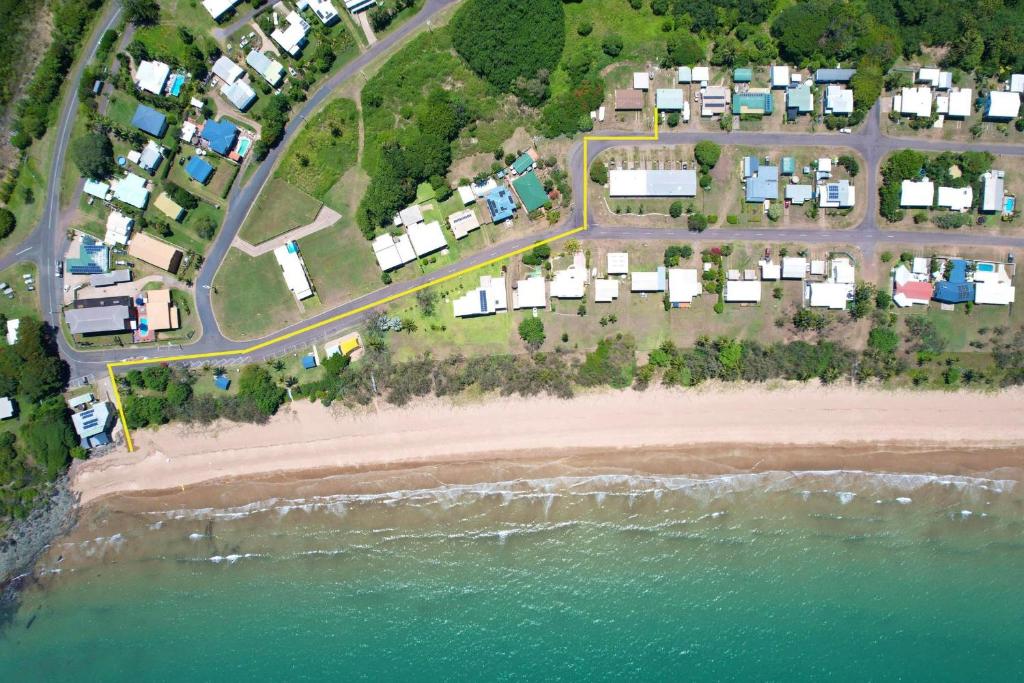 an aerial view of a beach with houses and the water at The Shack in Sarina