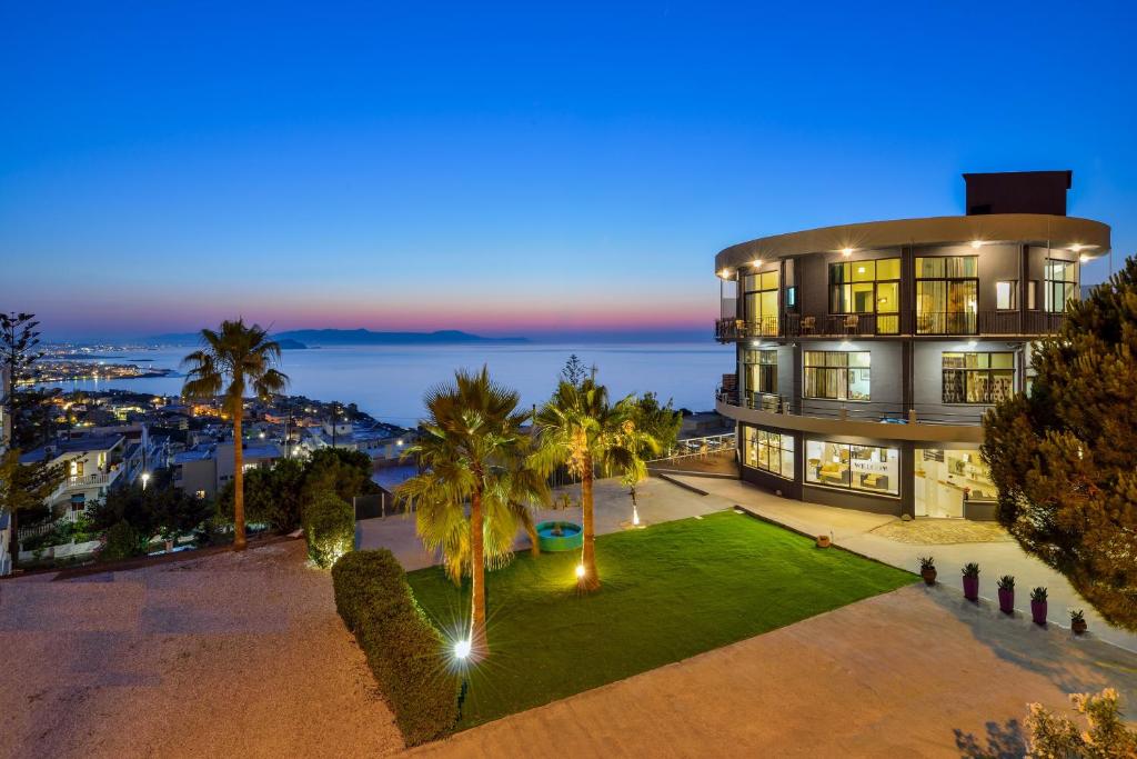 an aerial view of a large house with palm trees at Loucerna Suites Chania in Chania Town