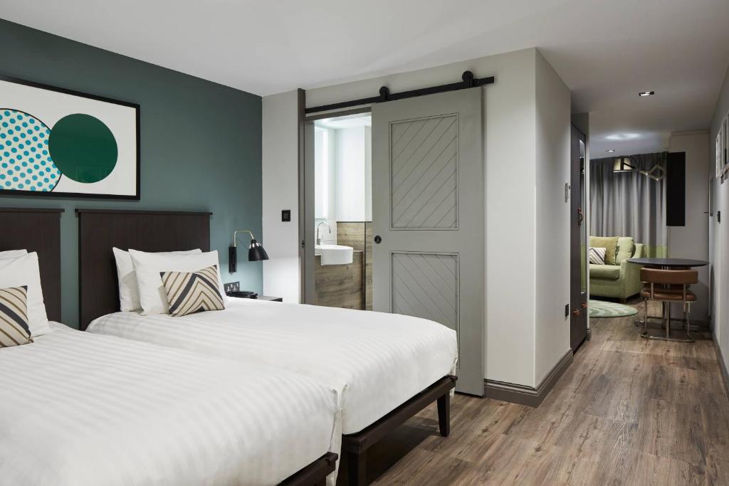 a bedroom with a large bed and a living room at Residence Inn by Marriott London Tower Bridge in London