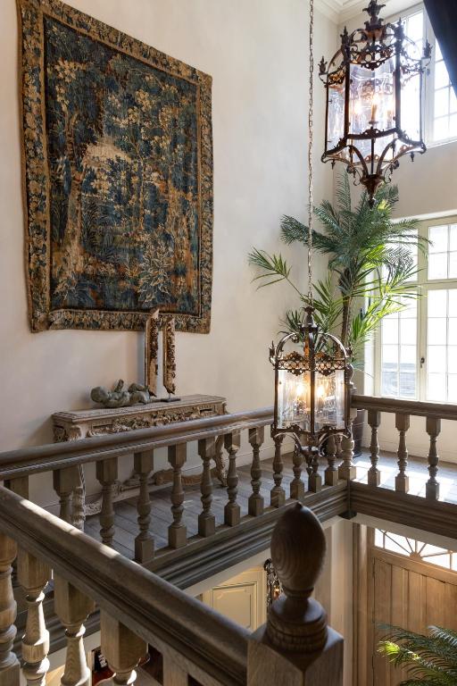 a tapestry on the wall above a staircase with a rug at The Notary in Bruges