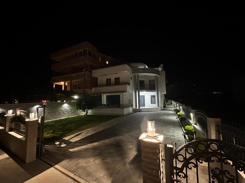 a night view of a house with a fence at Apartments Near The Coast - Milla in Ulcinj