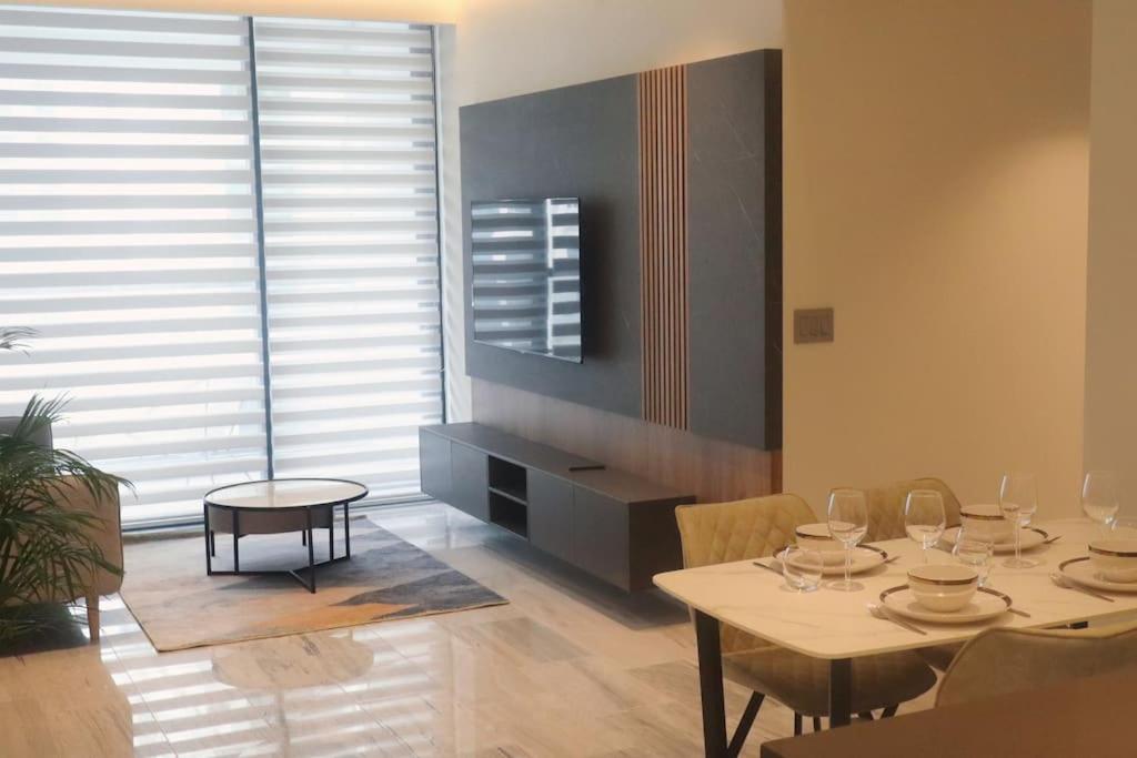uma sala de jantar com uma mesa e cadeiras e um quarto com uma janela em La comodidad de un hogar na Cidade do Panamá