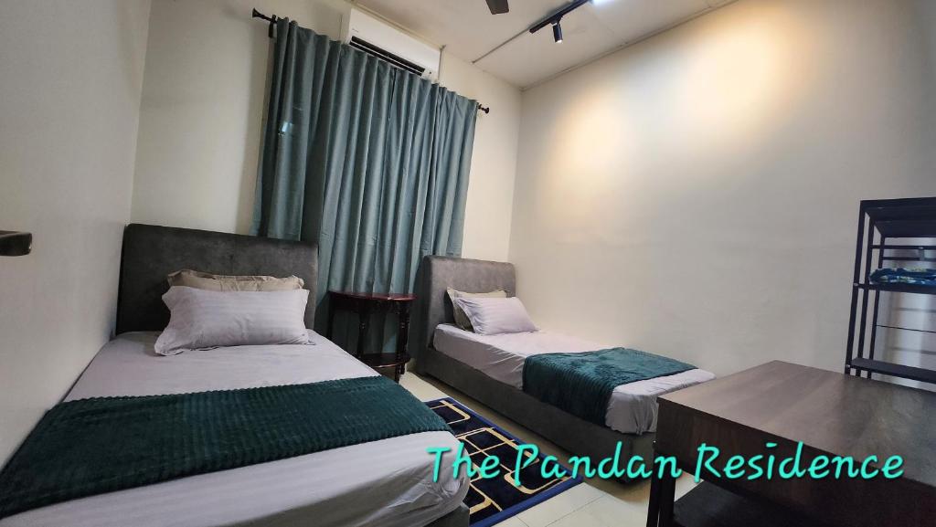 a room with two beds and a window at The Pandan Residence in Kuantan