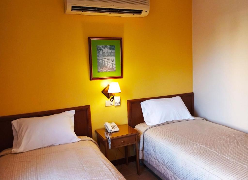 Postel nebo postele na pokoji v ubytování Hotel Bristol Asuncion