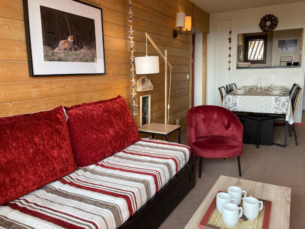 a living room with a couch and a red chair at Appartement Avoriaz, 3 pièces, 7 personnes - FR-1-634-89 in Morzine
