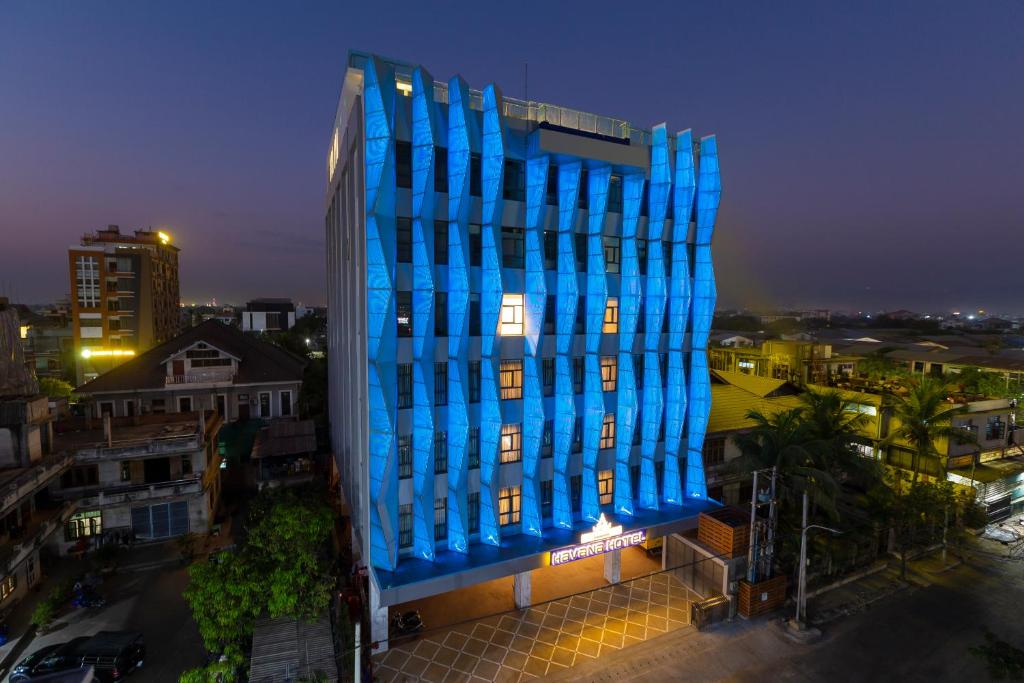 a blue building is lit up at night at Havana Hotel Mandalay in Mandalay