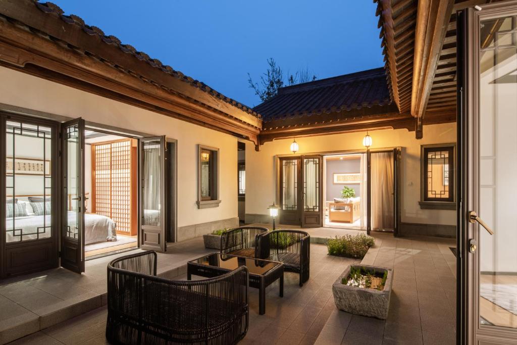 an outdoor patio with chairs and a table at 岷江书院人文度假酒店 in Chengdu