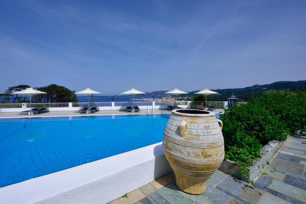 a large vase sitting next to a swimming pool at Kalidon Panorama Hotel in Kokkari