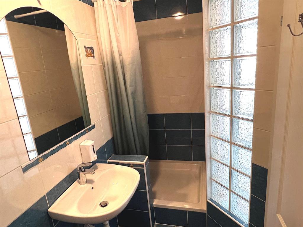 a bathroom with a sink and a shower at Apartments MiaMaja in Novalja