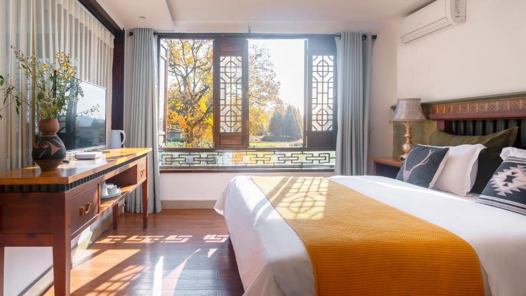 Postel nebo postele na pokoji v ubytování Alina Garden Boutique Resort Huangshan Hongcun