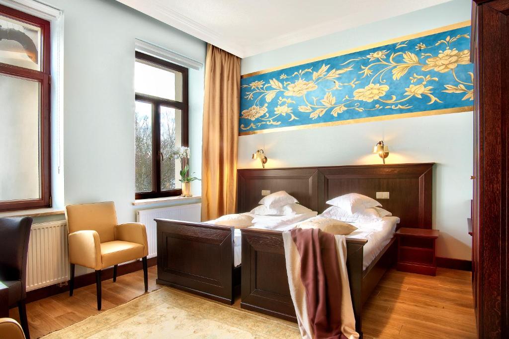 Posteľ alebo postele v izbe v ubytovaní BoutiqueHotel Aristo