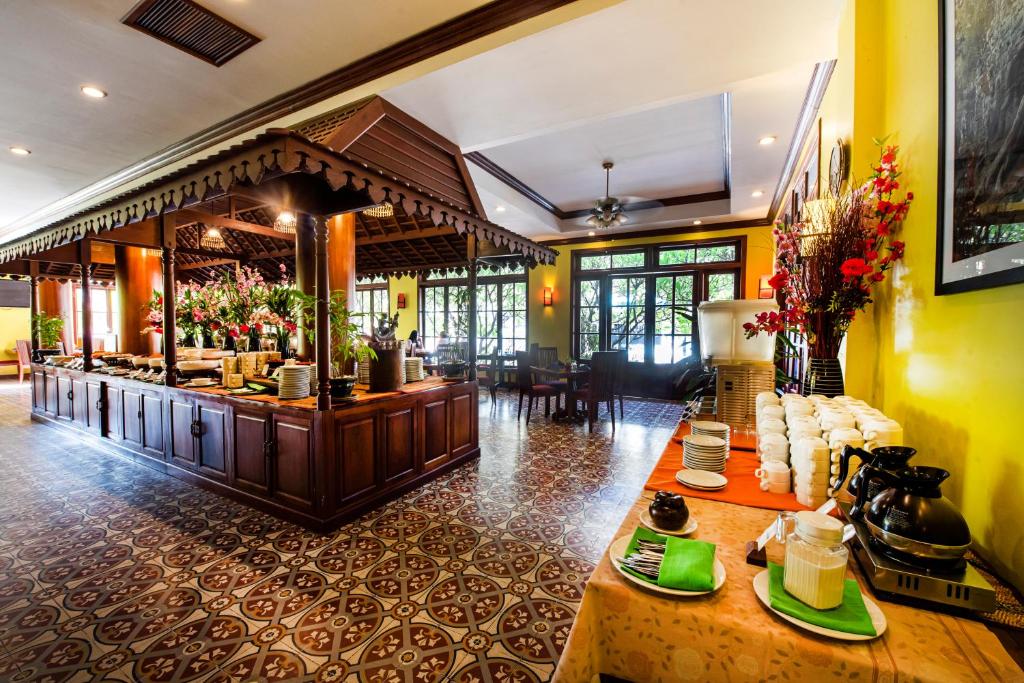 a restaurant with a counter with food on it at Royal Crown Hotel & Spa in Siem Reap