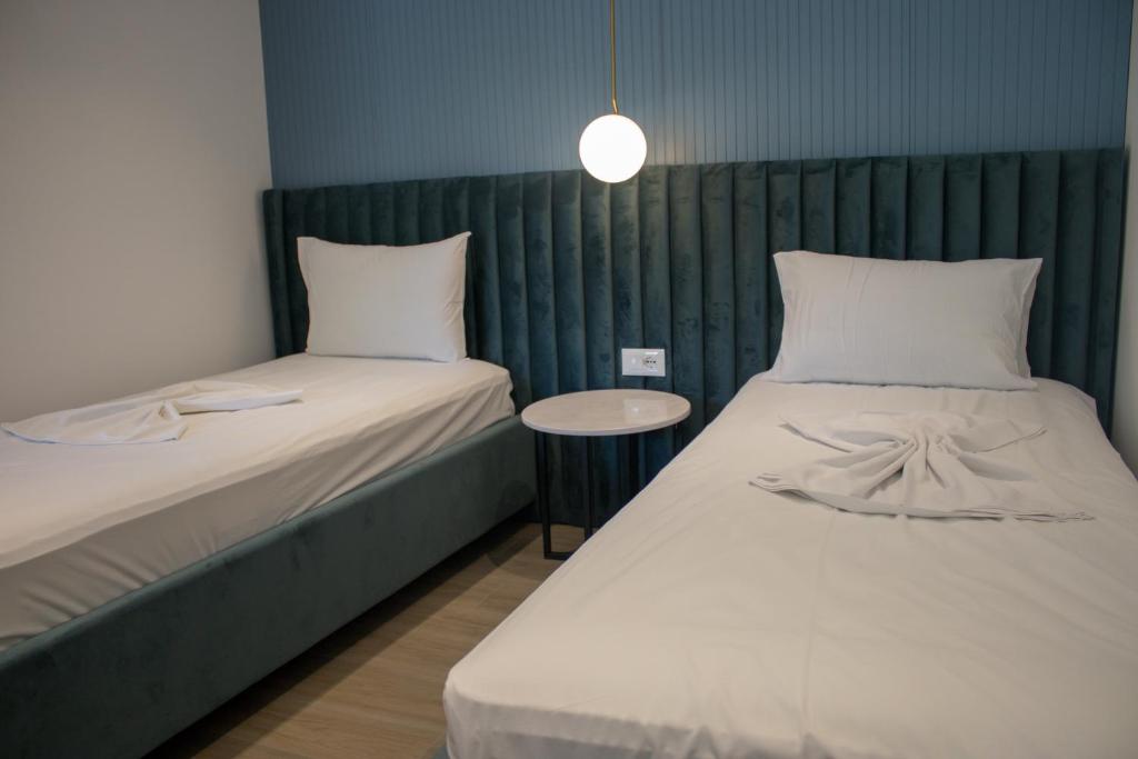 Postel nebo postele na pokoji v ubytování Perla Hotel