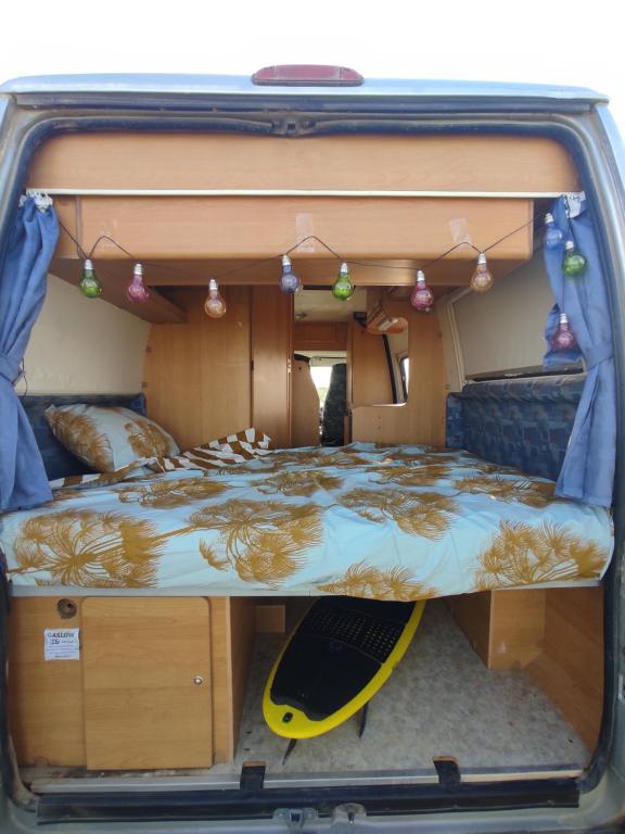 a bed in the back of a camper van at Keros Summer Camp in Kalliópi