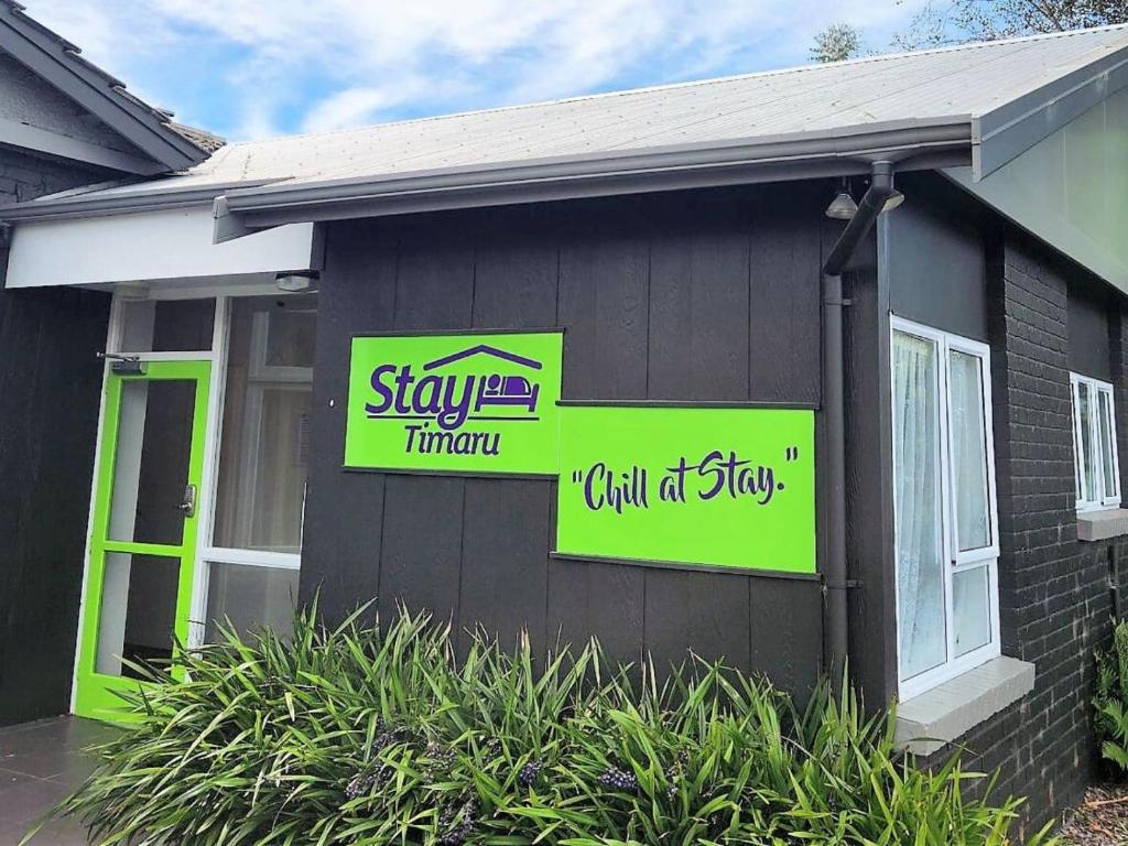 a house with signs on the side of it at Stay Timaru in Timaru