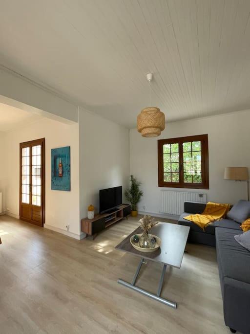 a living room with a couch and a table at La Villa de Niolon au coeur de la calanque vue mer in Le Rove