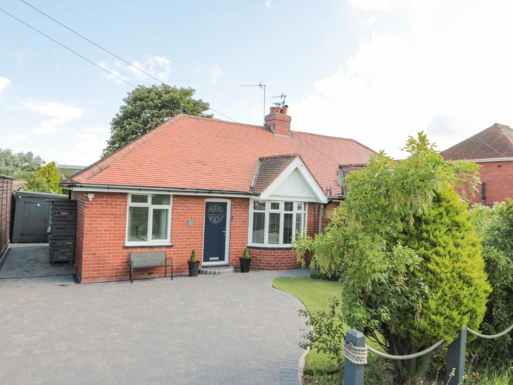 a red brick house with a red roof at Seaside House in Scarborough
