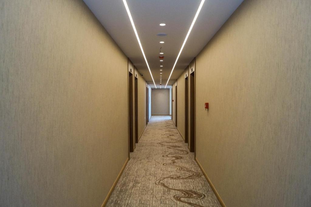 a hallway with a long aisle with a corridorngthngthngthngthngth at Red Hill Hotel in Tirana