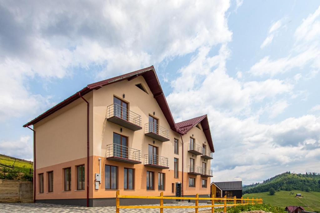 a building with a fence in front of it at Шепіт Лісу in Bukovel