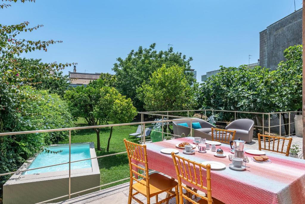 カルピニャーノ・サレンティーノにあるLa Salentina Otranto - Happy Rentalsのパティオ(テーブル、椅子付)、スイミングプールが備わります。